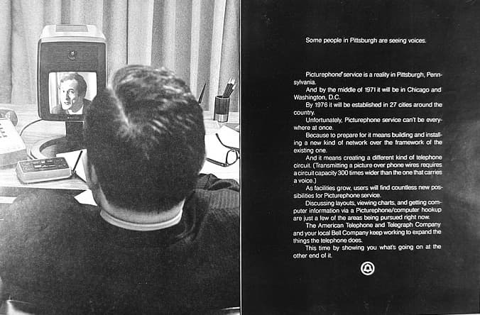 A two-page magazine advertisement in black and white. On the left, seen from behind, a man at a desk faces a small boxy screen showing another man's face. On the right, white text on a black field begins: Some people in Pittsburgh are seeing voices.